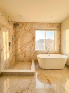bathroom renovation Toronto - freestanding soaker tub by the window and walk-in rain shower