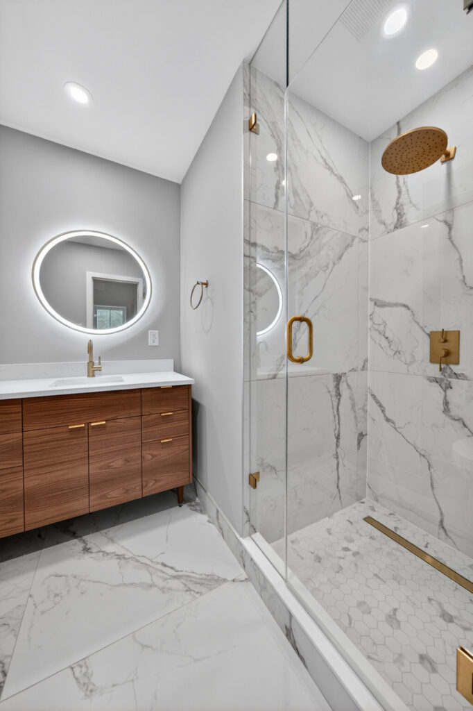 whole home renovation Summerhill - second floor bathroom with marble-look tile and walk-in glass shower