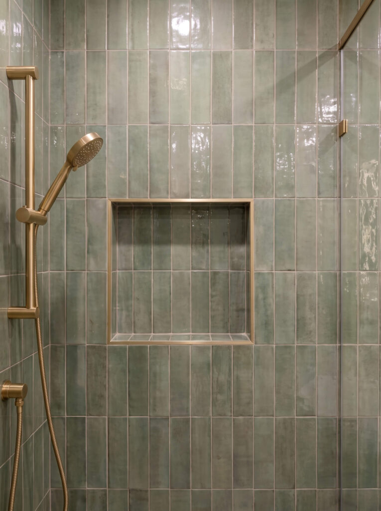 Calming green colour palette in a spa bathroom with a zellige tile feature wall